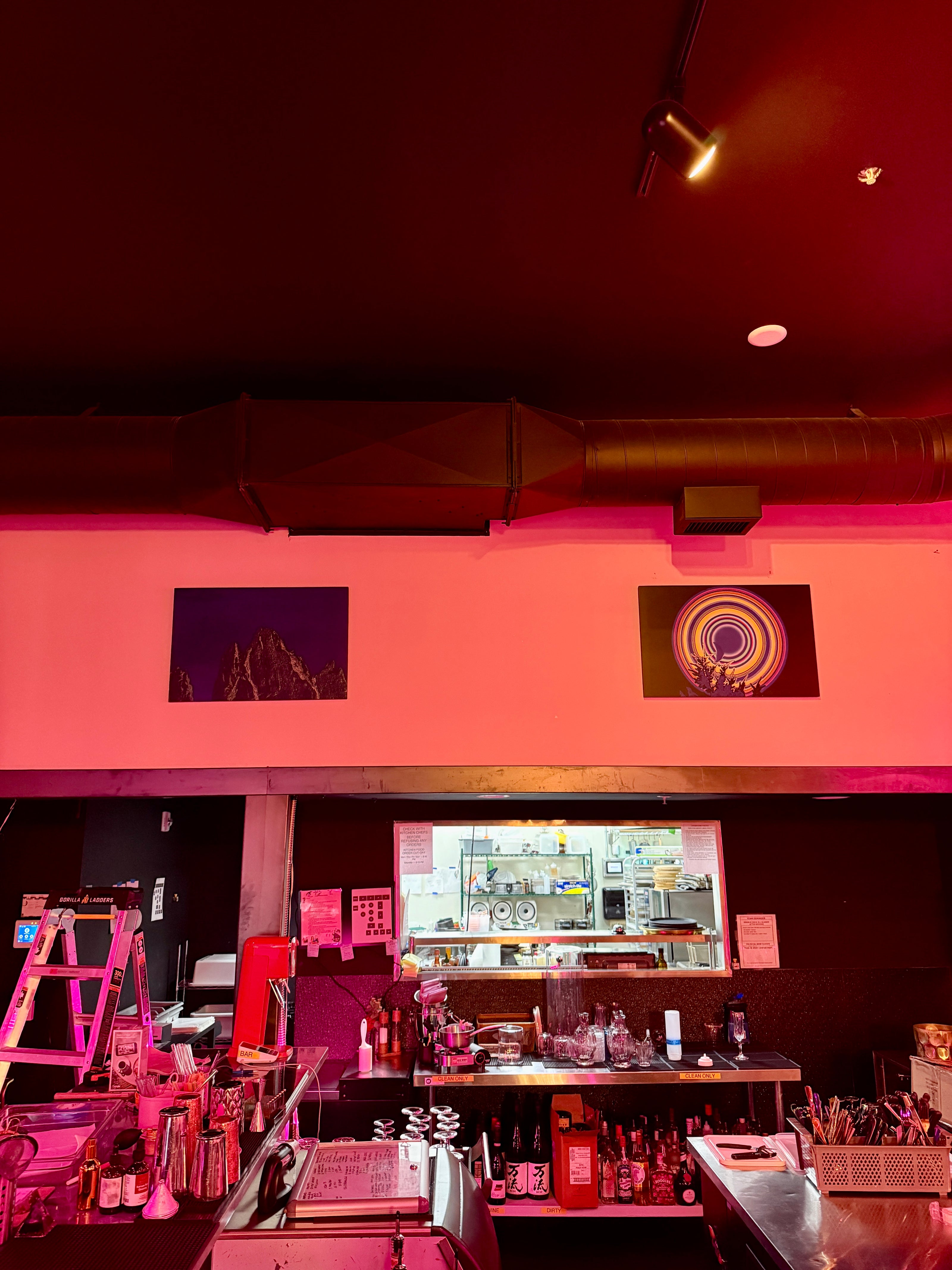 Offbeat art installation at Champagne Poetry in Portland featuring colorful modern wall art in a bar setting